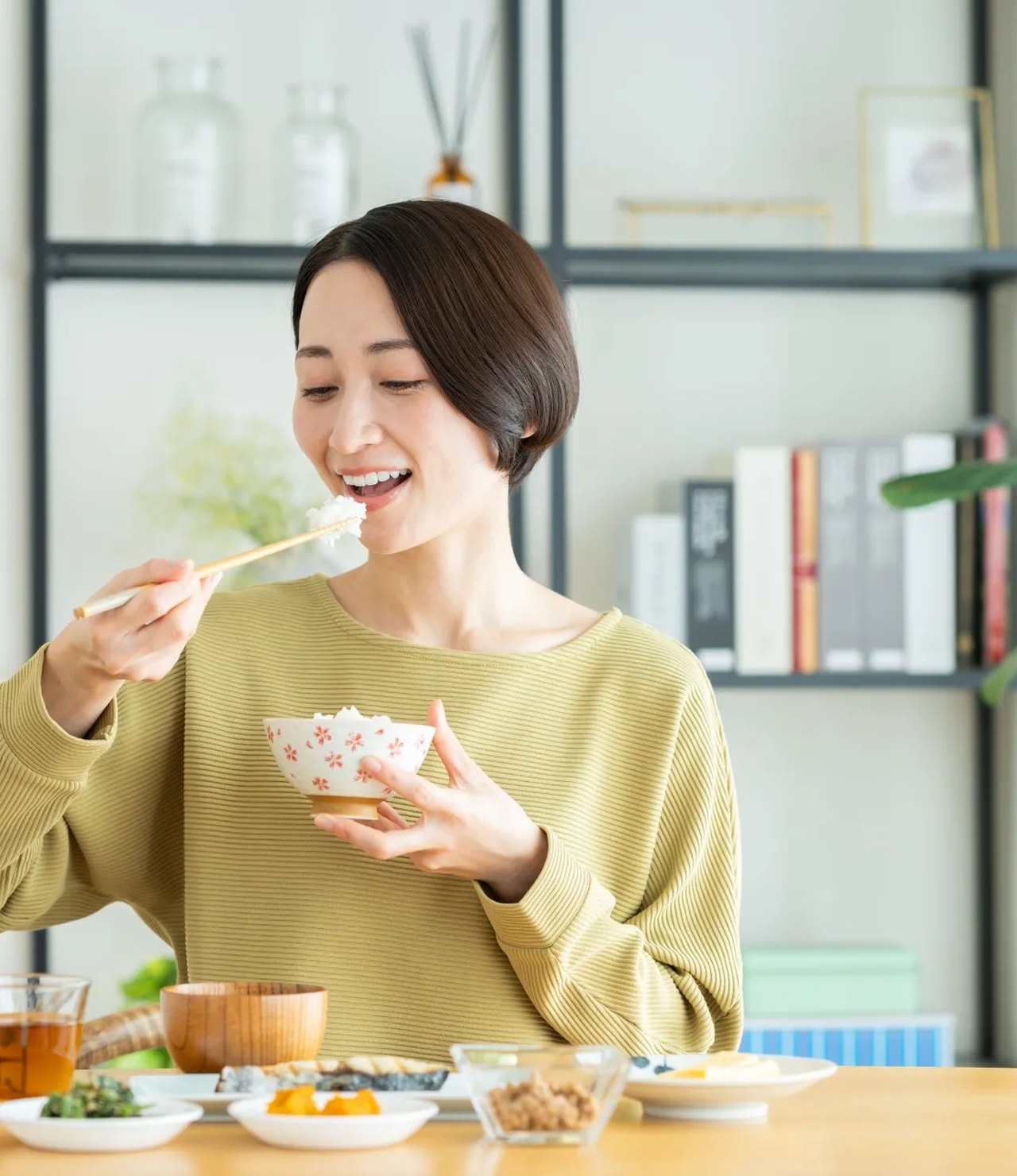 美味しそうにお米を食べる女性（岐阜県のかたちに切り抜いた写真）